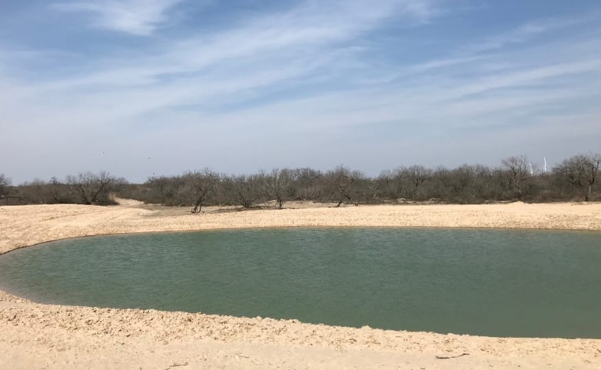 Previously completed earthwork and water-filled pond