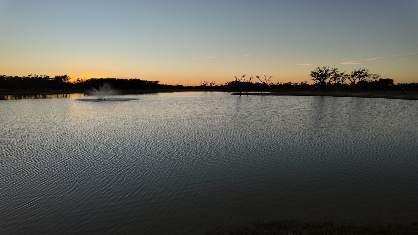 Southern Oaks RV Resort pond and fountain at sunset